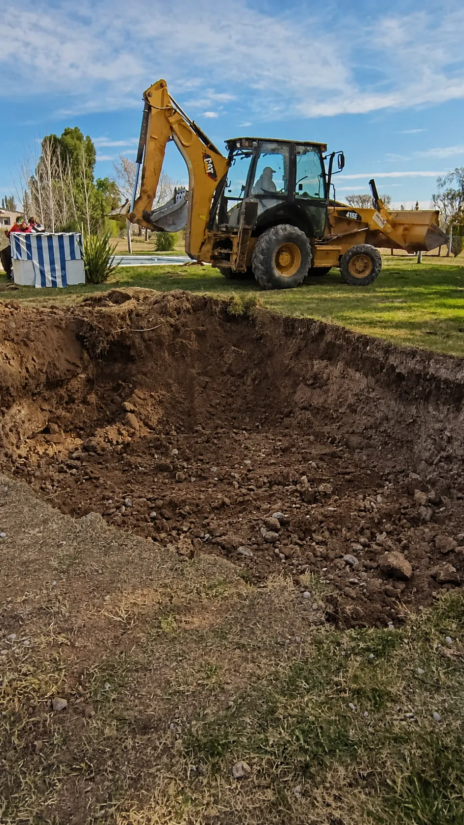 Retroexcavadora trabajando en un terreno rural